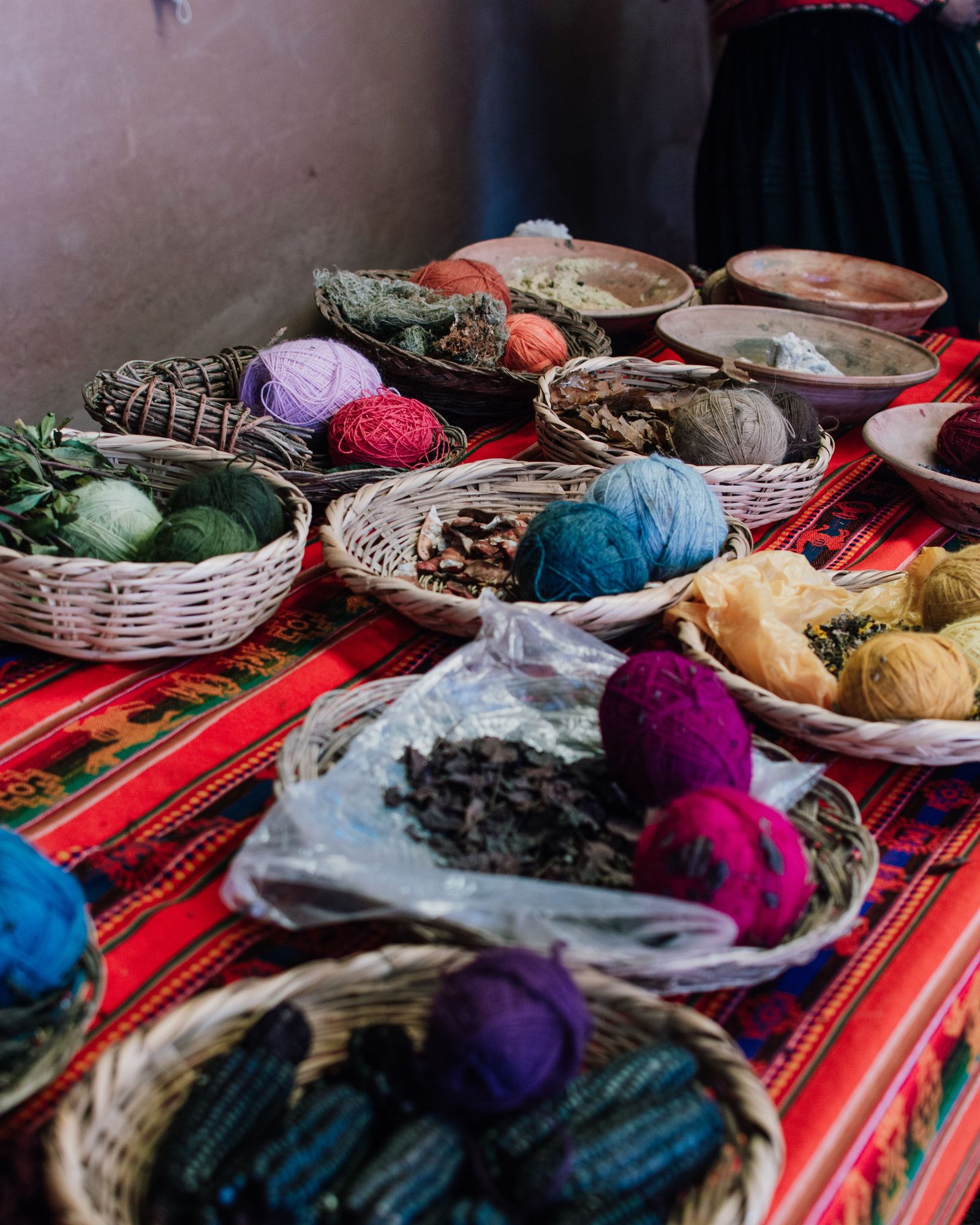 Baskets of hand-dyed wool yarn in many colors